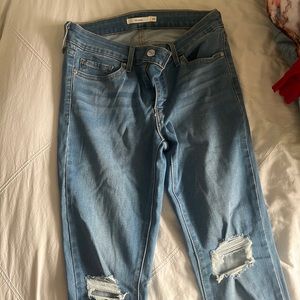 LEVIS size women’s 27 skinny jeans from levi blue wash with rips at the knees